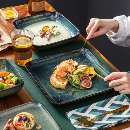The Vancasso Stern 16-Piece Green Square Stoneware Dinnerware Set features a unique reactive glaze, providing service for four